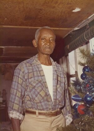 Tony (Shorty) Jackson next to his Christmas tree 1970s.jpg