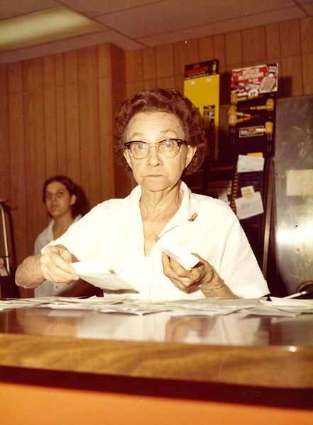 File:YMCA Restaurant Clara Metzer is working with checks in the foreground and Helen Lust (McFall) is standing in the background.jpg