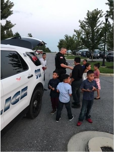 File:Officer Brandon Smith passing out his trading cards. Thanks to Chief Milt Frech, August 2018.jpg