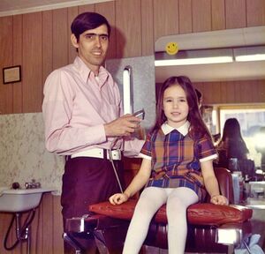 Clyde Reed giving hair cut to his daughter Connie.jpg
