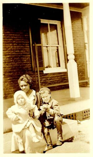 Edna Robinson Holland holding 2 Brunswick children she helped raise.jpg