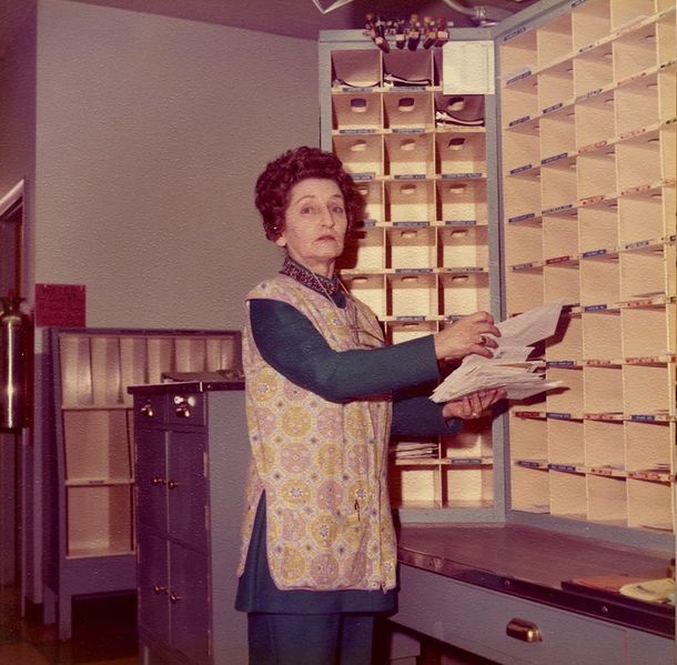 File:Post Office, Mary Webber is sorting the mail..jpg