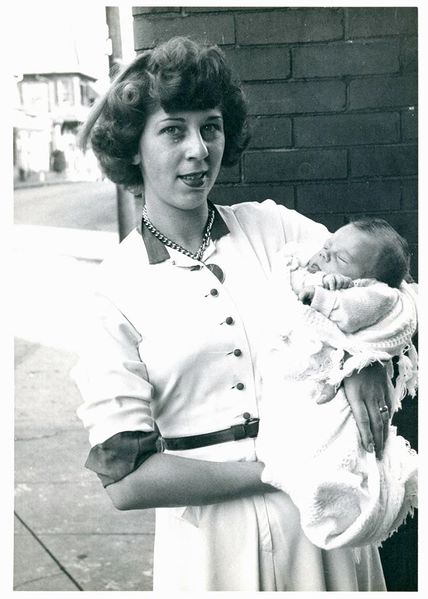 File:Lois Nelson with her newborn son Johnny in front of Kaplon's in the early 1950s. Photo from Smoketown History.jpg