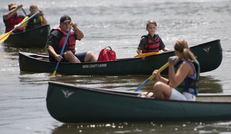 File:Kids, COPS and Canoe event, Brunswick Police Lt Keith Donovan, center canoe and Quinton Wade navigate the Potomac River with other officers and children.jpg
