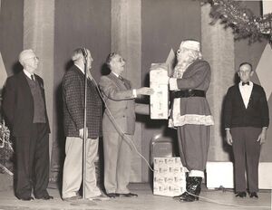 Mayor - Cummings accepts a gift from Santa.jpg