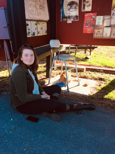 File:Lauren Kenny feed Jose the official Brunswick Campground resident cat March 2018. Photo Caroline Mansfield.jpg
