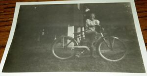 Ann Spurrier riding her bike down at the river cabin..jpg