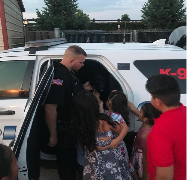 File:Officer Brandon Smith (K9) with Trex passing out his trading cards. Thanks to Chief Milt Frech, August 2018.jpg