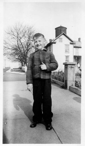 Lee Smith standing in front of his family.jpg